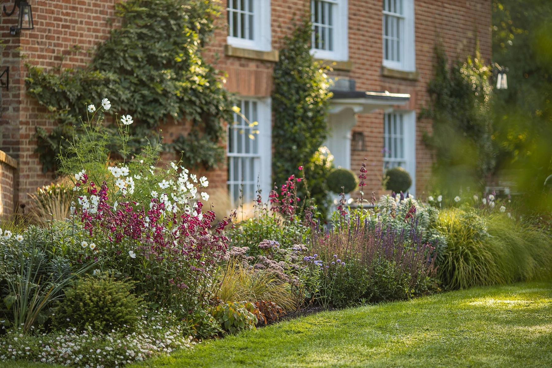 Colourful borders and structured planting within a bespoke Cotswolds kitchen garden design