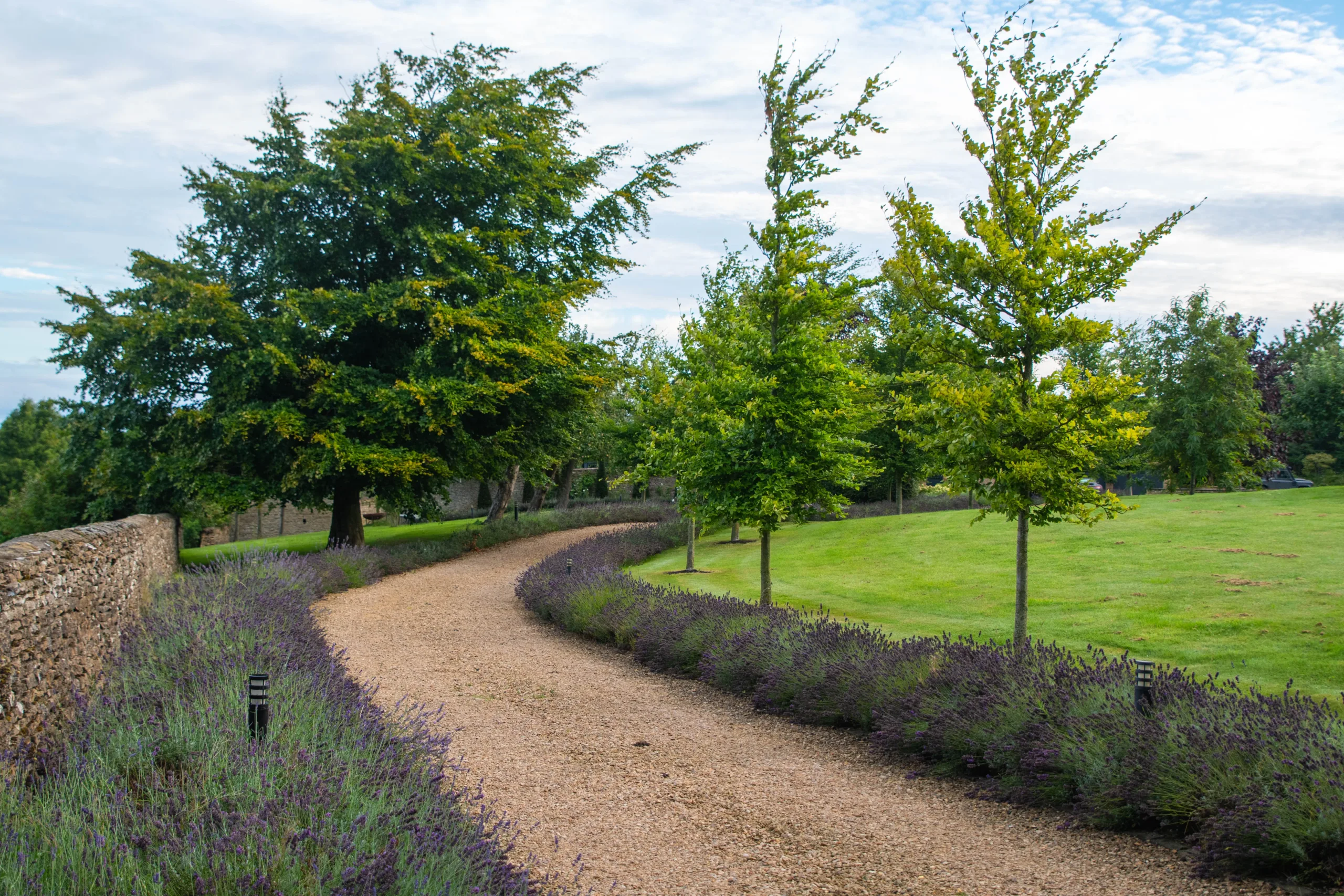 Oxfordshire farmhouse garden design showcasing tranquil water features and greenery