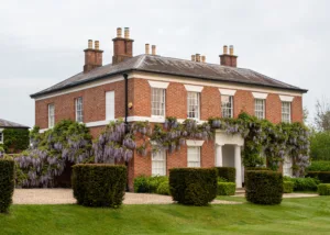 Warwickshire country house garden with wisteria climbing Georgian façade