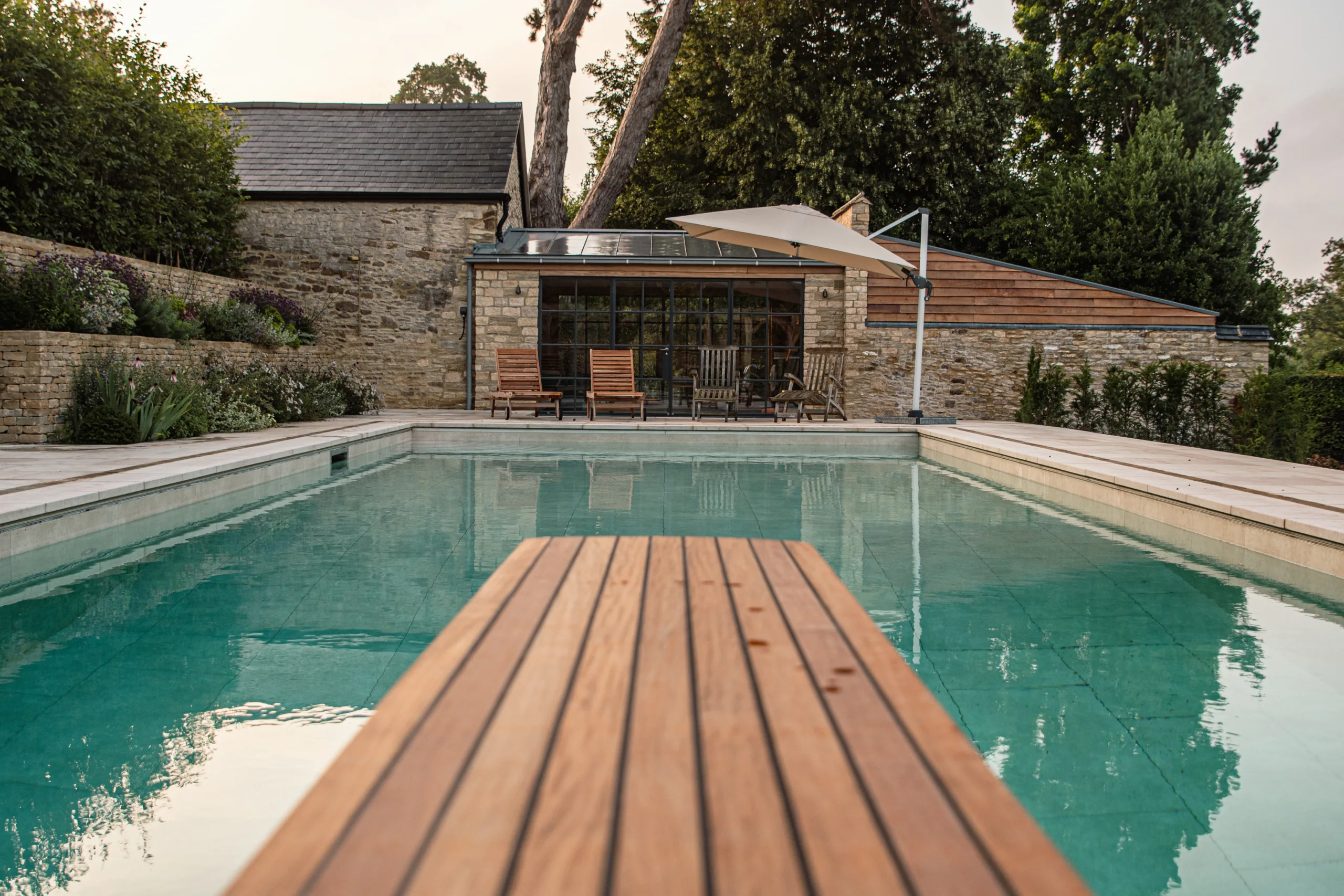 Modern outdoor pool with architectural planting and paving