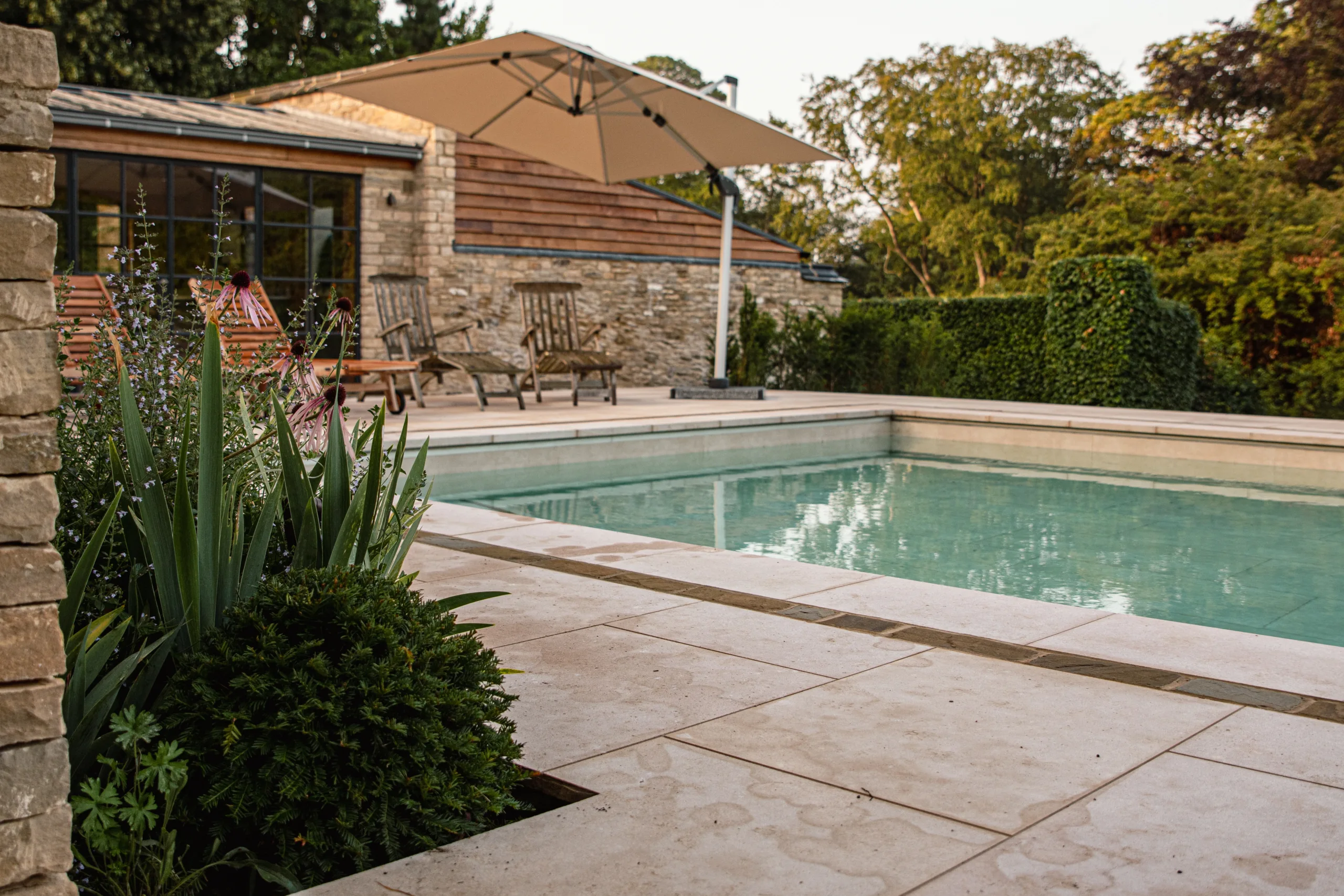 Luxury swimming pool with reflecting rill and modern landscaping