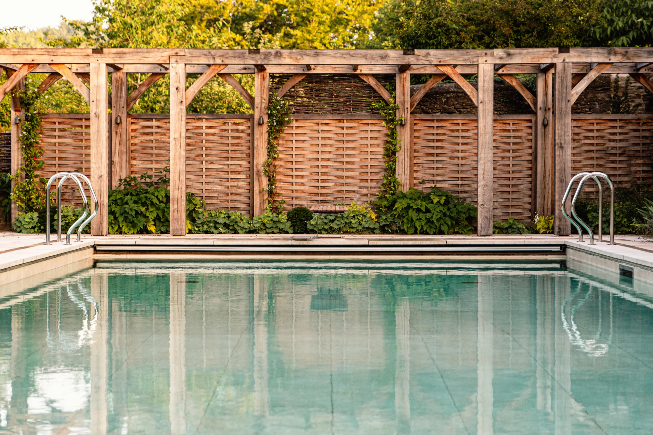Reflective pool surface framed by modern stone coping