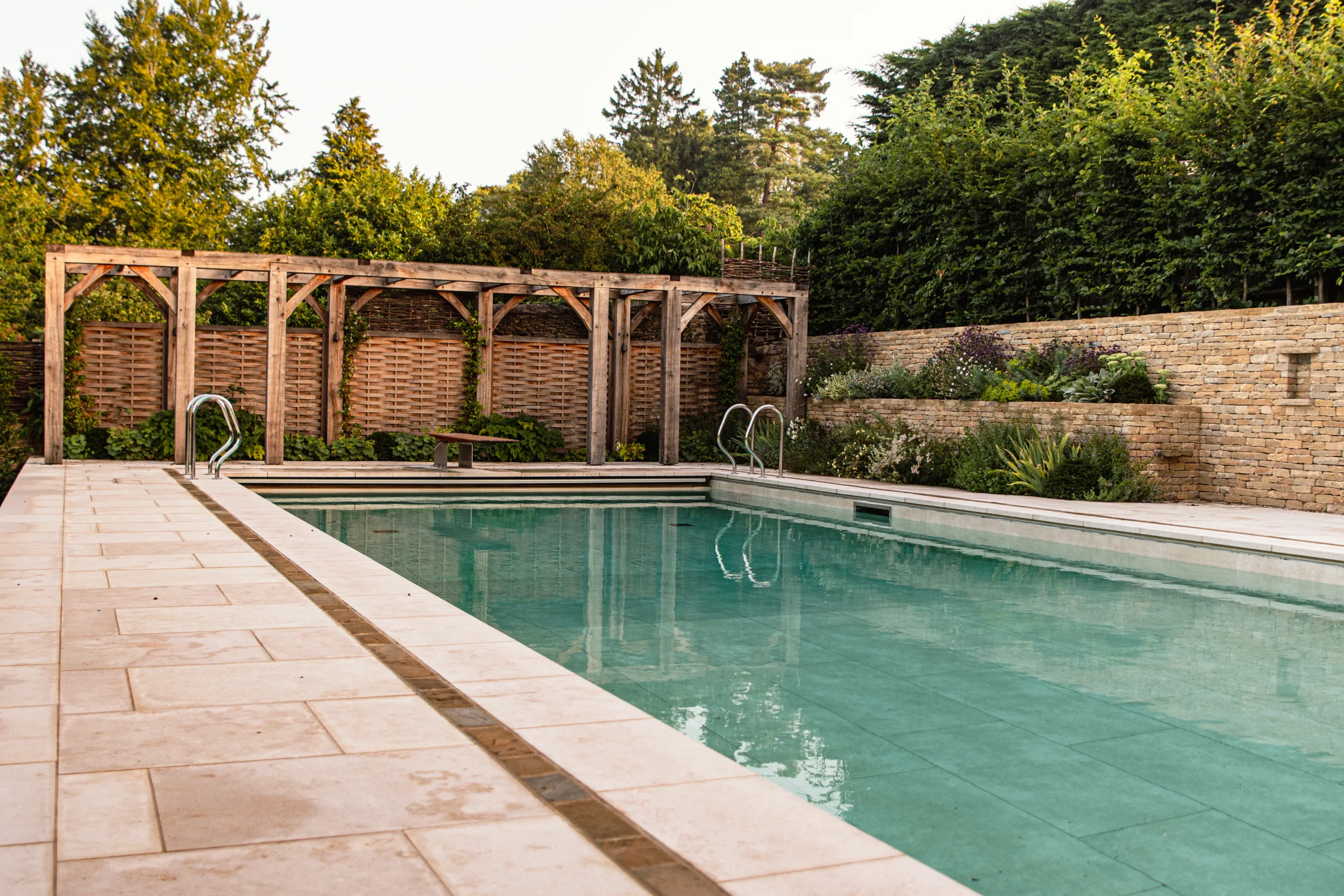 Modern countryside garden design with structured planting and water elements